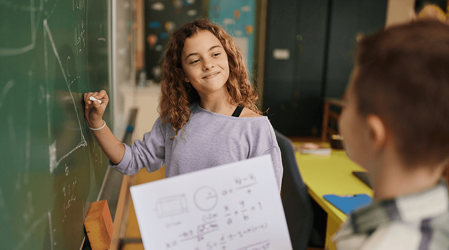 Student smiling, holding paper